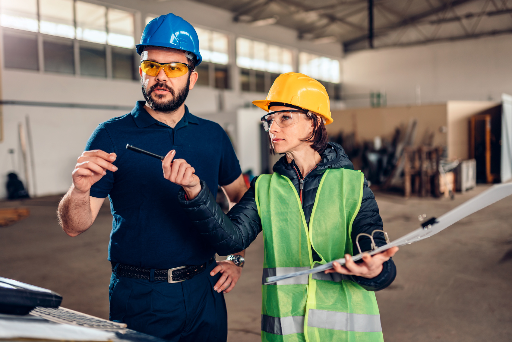 Workplace safety inspector writing a report at industrial factory